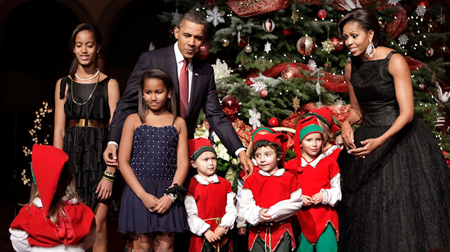 U.S. President Barack Obama, first lady Michelle Obama and their daughters Malia (L), Sasha (2nd L) greet children dressed as elves at the Christmas in Washington Celebration at the National Building Museum in Washington, DC, U.S. December 12, 2010.
