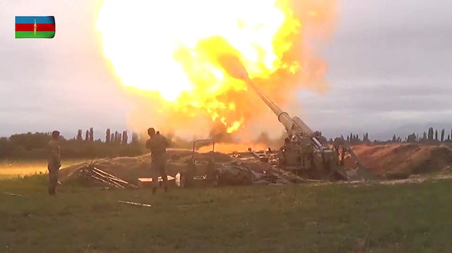 A still image from a video released by the Azerbaijan's Defence Ministry shows members of Azeri armed forces firing artillery during clashes between Armenia and Azerbaijan over the territory of Nagorno-Karabakh in an unidentified location, in this still image from footage released September 28, 2020. Defence Ministry of Azerbaijan/Handout via REUTERS 