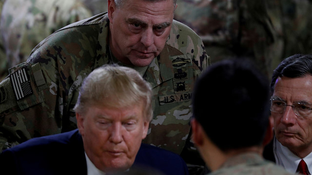 U.S. President Donald Trump eats dinner near General Mark Milley, Chairman of the Joint Chiefs of Staff, Senator John Barrasso of Wyoming and U.S. troops at a Thanksgiving dinner event during a surprise visit at Bagram Air Base in Afghanistan, November 28, 2019.