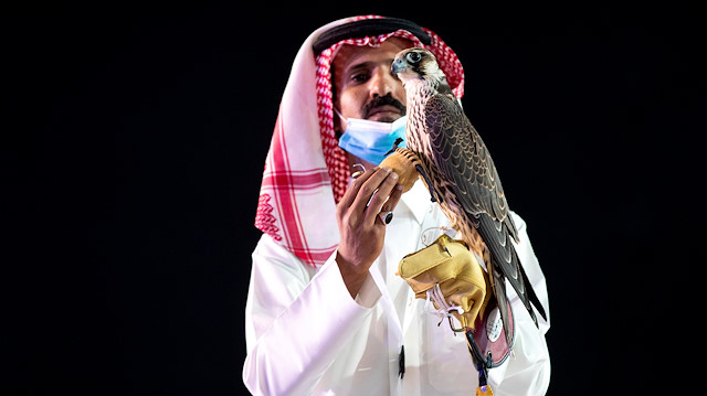 A Saudi man displays a falcon which was sold for SR650,000 (US$173284) during an auction at Saudi Falcons Club Auction in King Abdulaziz Festival in Mulham, north of Riyadh, Saudi Arabia, October 13, 2020, Picture taken October 13, 2020. Media Center Saudi Falcons Club Auction 