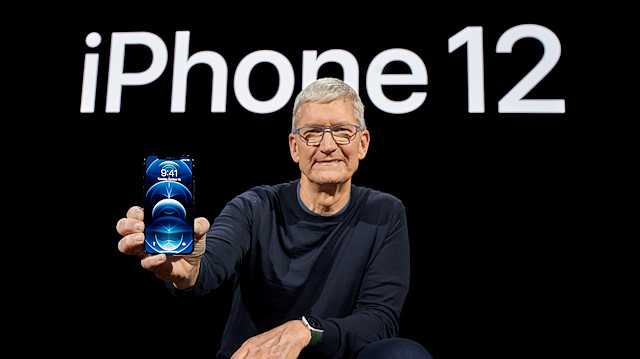 Apple CEO Tim Cook poses with the all-new iPhone 12 Pro at Apple Park in Cupertino, California, U.S. in a photo released October 13, 2020