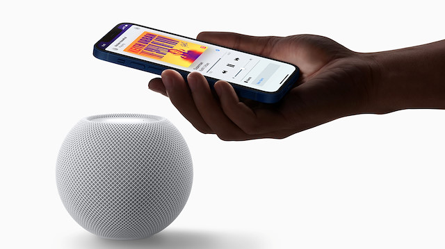 Apple's HomePod mini is seen with an iPhone in a photograph released in Cupertino, California, U.S. October 13, 2020