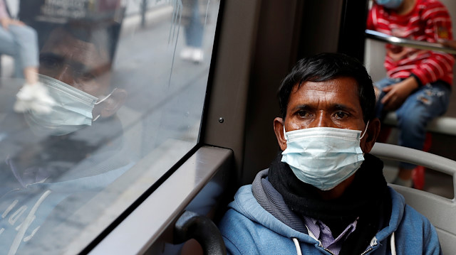 Passengers wearing protective face masks travel on a bus, as Italy adopts new restrictions aimed at curbing a surge in the coronavirus disease (COVID-19) infections, in Rome, Italy October 15, 2020.