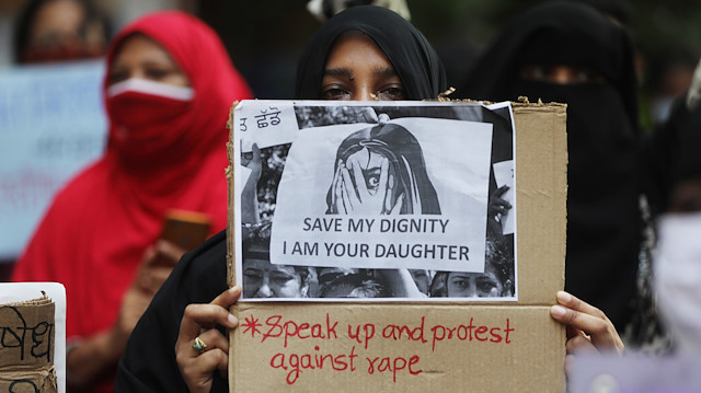 Women hold placards during a protest after the death of a rape victim, on a street in Mumbai, India, October, 6, 2020.