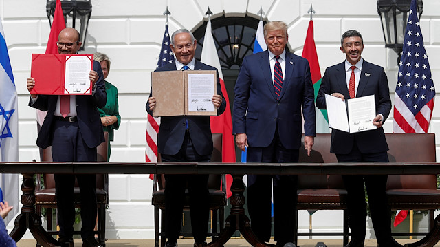 Bahrain’s Foreign Minister Abdullatif Al Zayani, Israel's Prime Minister Benjamin Netanyahu and United Arab Emirates (UAE) Foreign Minister Abdullah bin Zayed display their copies of signed agreements while U.S. President Donald Trump looks on as they participate in the signing ceremony of the Abraham Accords, normalizing relations between Israel and some of its Middle East neighbors, in a strategic realignment of Middle Eastern countries against Iran, on the South Lawn of the White House in Washington, U.S., September 15, 2020.