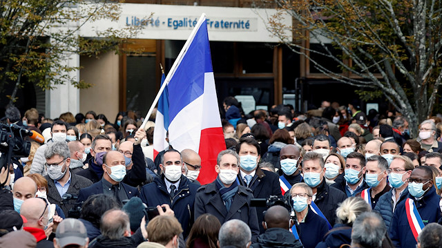 FILE PHOTO: People gather in front of the Bois d'Aulne college after the attack in the Paris suburb of Conflans St Honorine, France, October 17, 2020. REUTERS/Charles Platiau/File Photo

