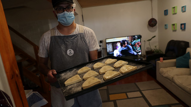 Pedro Campos, who lost his job last year when the restaurant where he worked closed after riots in Santiago broke out over social injustice and entrenched inequality, prepares to bake and sell homemade bread to his neighbours at his house at Puente Alto area, on the outskirts of Santiago, Chile October 6, 2020. Picture taken October 6, 2020.