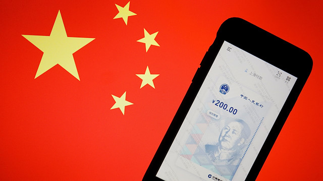 China's official app for digital yuan is seen on a mobile phone placed in front of an image of the Chinese flag, in this illustration picture taken October 16, 2020. 