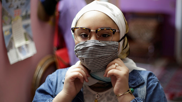 Sama Mohamed, 12, wears a protective face mask amid the coronavirus disease (COVID-19) pandemic before her school day, at her room in Cairo, Egypt, October 13, 2020. Picture taken October 13, 2020. REUTERS/Hayam Adel

