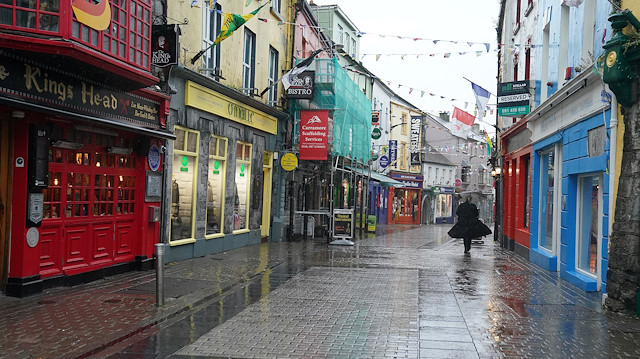 A woman walks through an empty city centre shopping street as the coronavirus disease (COVID-19) outbreak continues, in Galway, Ireland, October 19, 2020. 