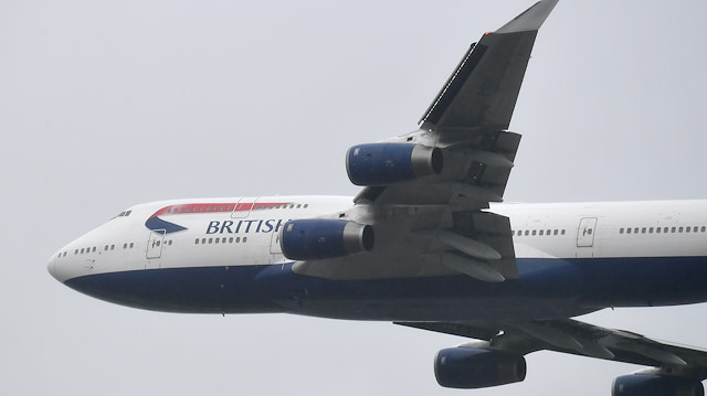 FILE PHOTO: A British Airways Boeing 747 does a flypast over London Heathrow airport on it's final flight, the last of 31 jumbo jets to be retired early by the airline due to the coronavirus disease (COVID-19) pandemic, in London, Britain October 8, 2020. REUTERS/Toby Melville/File Photo

