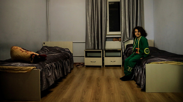 Sahil Memedzade, 6, sits in a dormitory room where he is settled with his family after his home was ruined by an Armenian rocket 