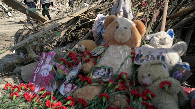 Carnations, teddy bears and pictures are laid to the blast site 