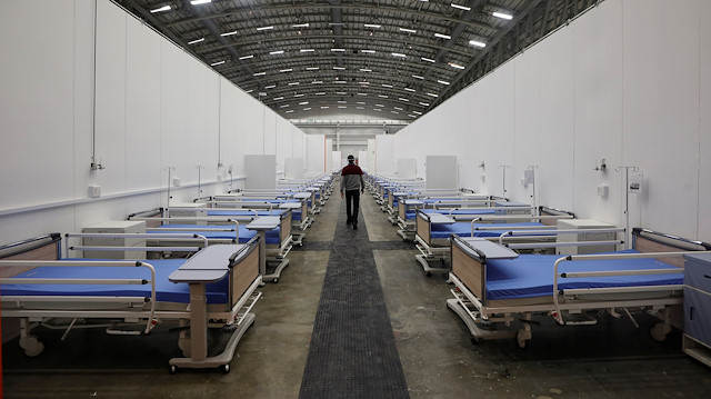 File photo: A health department official walks past beds set up at a temporary field hospital to deal with an expected surge in cases of the coronavirus disease (COVID-19) at the Cape Town International Convention Centre in Cape Town, South Africa May 26, 2020. 