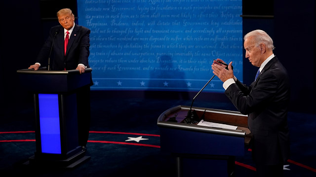 Democratic presidential candidate former Vice President Joe Biden answers a question as President Donald Trump listens during the second and final presidential debate at the Curb Event Center at Belmont University in Nashville, Tennessee, U.S., October 22, 2020