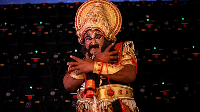 An artist dressed as a demon king Ravana reacts as he waits backstage before performing Ramlila, a re-enactment of the life of Hindu Lord Rama, during Dussehra festival celebrations, amid the outbreak of the coronavirus disease (COVID-19), in New Delhi, India October 25, 2020. REUTERS/Adnan Abidi

