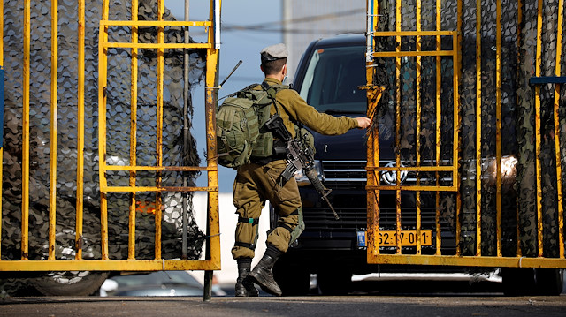 An Israeli soldier opens a gate at a military base leading to the border crossing with Lebanon at Rosh Hanikra, northern Israel October 28, 2020. REUTERS/Amir Cohen

