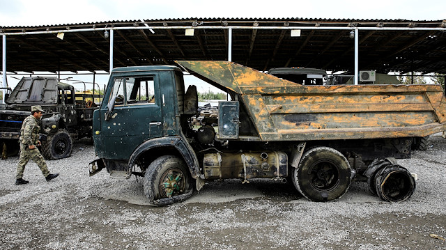 An Azeri soldier walks past an Armenian military truck which was seized by the Azerbaijan army during the fighting over the breakaway region of Nagorno-Karabakh, near the city of Barda, Azerbaijan October 21, 2020. REUTERS/Umit Bektas

