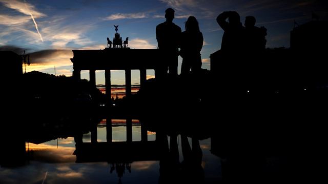 People stand in front of Brandenburg gate during the country's month-long COVID-19 lockdown, in Berlin, Germany, November 2, 2020