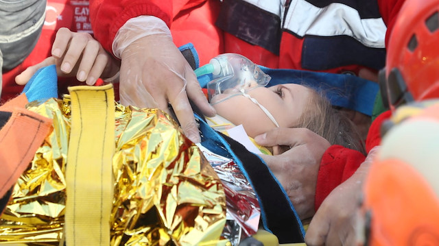 Rescue workers carry a 4-year-old girl, Ayla Gezgin, out from a collapsed building after an earthquake in the Aegean port city of Izmir, Turkey November 3, 2020. Turkey's Disaster and Emergency Management Presidency (AFAD)/Handout via REUTERS