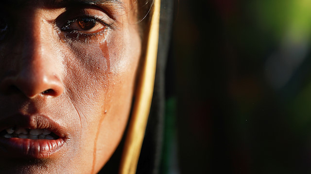 FILE PHOTO: Amina Khatun, a 30-year-old Rohingya refugee who fled with her family from Myanmar a day before, cries after she, along with thousands of newly arrived refugees, spent a night by the road between refugee camps near Cox's Bazar, Bangladesh, October 10, 2017. REUTERS/Damir Sagolj/File Photo 