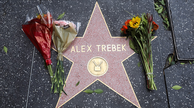 Flowers are placed on the star on the Hollywood Walk of Fame of TV host Alex Trebek in Los Angeles, California, U.S., November 8, 2020.
