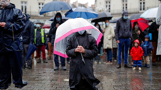 Parishioners wearing protective face masks pray at Graslin square during an open air mass in Nantes, as public masses are suspended during the second national lockdown as part of the measures to fight a second wave of the coronavirus disease (COVID-19), in France, November 15, 2020. REUTERS/Stephane Mahe TPX IMAGES OF THE DAY

