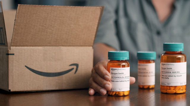 File photo: A person is seen with bottles of medication with branding for Amazon Pharmacy