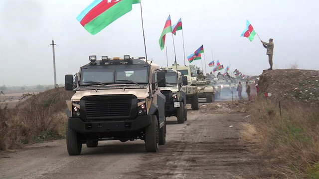 A still image from a video released by Azerbaijan's Defence Ministry shows military vehicles driving along a road as Azerbaijan army units enter the Aghdam region of Nagorno-Karabakh 

