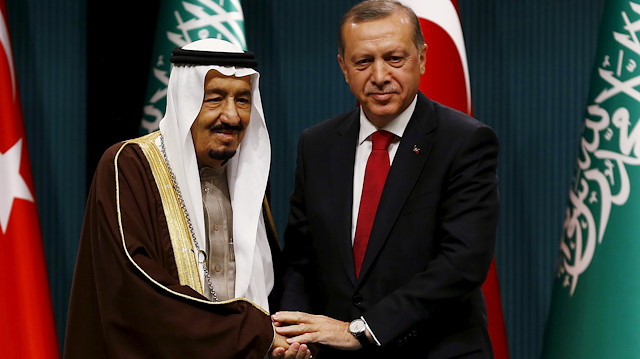 Turkey's President Tayyip Erdogan (R) and Saudi King Salman shake hands 