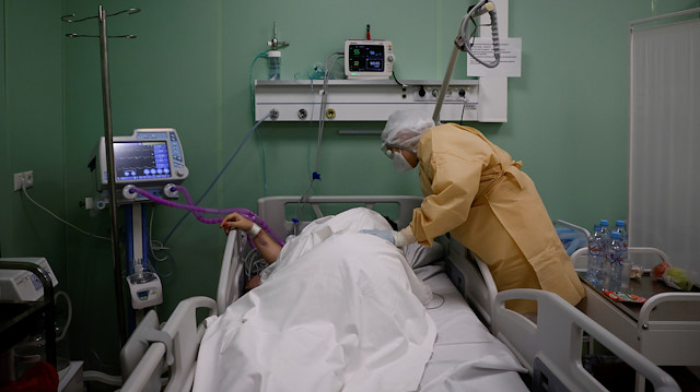 A patient receives medical assistance in an intensive care unit inside a pavilion of the Exhibition of Achievements of National Economy (VDNH), which was converted into a temporary hospital for people suffering from the coronavirus disease (COVID-19), in Moscow, Russia November 17, 2020. Picture taken November 17, 2020. REUTERS/Maxim Shemetov

