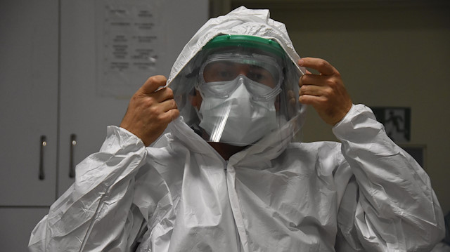 Sağlık çalışanları, kendilerini virüsten korumak için 3 kat giyinmek zorunda kalıyor.
