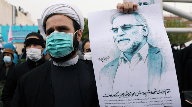 A protester holds a picture of Mohsen Fakhrizadeh