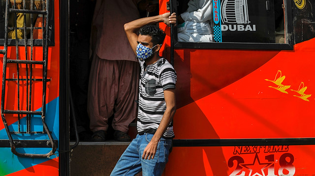 A man wears a protective mask as he rides on a bus amid the outbreak of the coronavirus 
