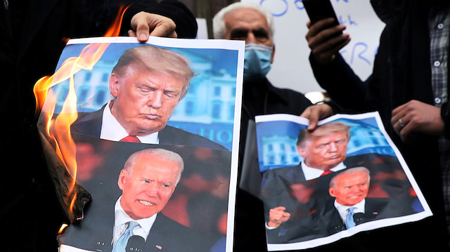 Protesters burn pictures of U.S. President-elect Joe Biden 