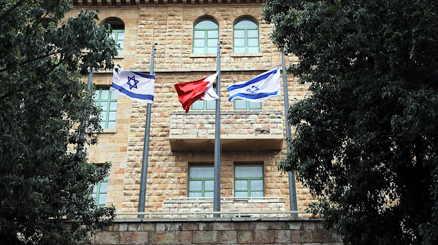 The national flags of Israel and Bahrain flutter at the entrance of the King David Hotel 