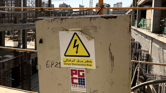 A warning sign in Persian with the company logo of Iranian engineering firm Padideh is seen 