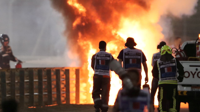 FILE PHOTO: Formula One F1 - Bahrain Grand Prix - Bahrain International Circuit, Sakhir, Bahrain - November 29, 2020 Flames seen from the crash scene after Haas' Romain Grosjean crashed out at the start of the race Pool via REUTERS/Kamran Jebreili/File Photo

