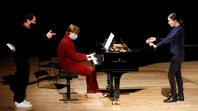 Director Simon Valastro, pianist Christiphe Vazan and singer Pauline Texier, members of the Opera de Paris Academy, rehearse at the Bastille Opera in Paris as French theatres, cinemas and museums which have been on the second-wave COVID-19 lockdown will not reopen this year in France, December 11, 2020