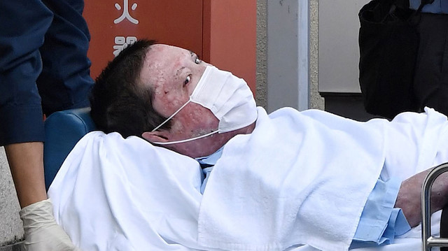 Shinji Aoba, a suspected arsonist who is suspected of killing 36 people at Kyoto Animation in July 2019, is seen on a stretcher as he is carried to Fushimi police station after being arrested in Kyoto, western Japan, in this photo taken by Kyodo May 27, 2020.