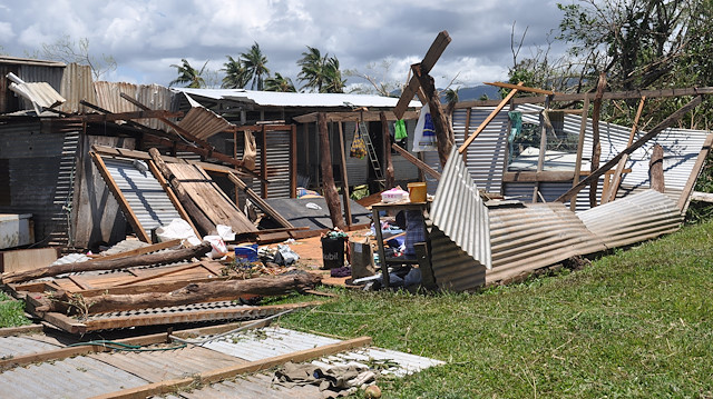 People return to their house, completely destroyed by Cyclone Yasa, northern Bua, Vanua Levu, Fiji, December 19, 2020, in this photo supplied by IFRC. Photo taken December 19, 2020. Ponipate/IFRC/via Reuters