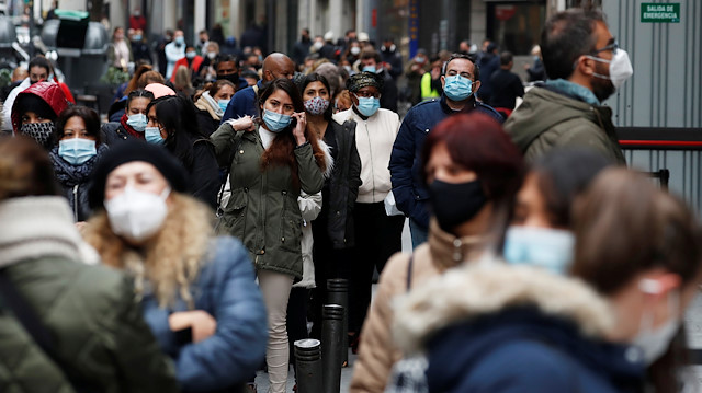 People wearing protective masks wait in line to buy lottery tickets of the Spanish Christmas Lottery "El Gordo", amid the coronavirus disease (COVID-19) outbreak, in Madrid, Spain December 21, 2020.