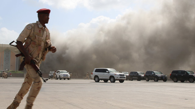 A security personnel member reacts during an attack on Aden airport moments after a plane landed carrying a newly formed cabinet for government-held parts of Yemen, in Aden, Yemen December 30, 2020. 