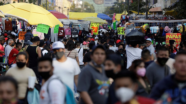 People walk along a crowded commercial street amid the outbreak of coronavirus disease (COVID-19) in downtown Mexico City, Mexico December 19, 2020.