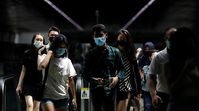 People wearing face masks leave a train station in Singapore December 8, 2020.
