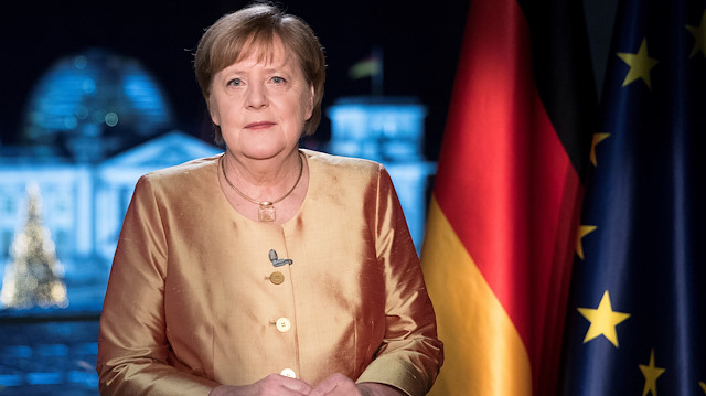 German Chancellor Angela Merkel poses for photographs 