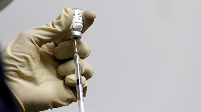  A medic fills a syringe with COVAXIN