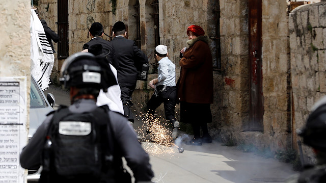 A stun grenade explodes during scuffles with ultra-Orthodox Jews