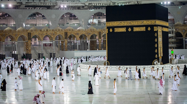 Muslims, keeping a safe social distance, perform Umrah at the Grand Mosque