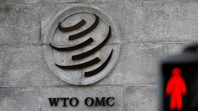 A logo is pictured outside the World Trade Organization (WTO) headquarters next to a red traffic light in Geneva, Switzerland, October 2, 2018.